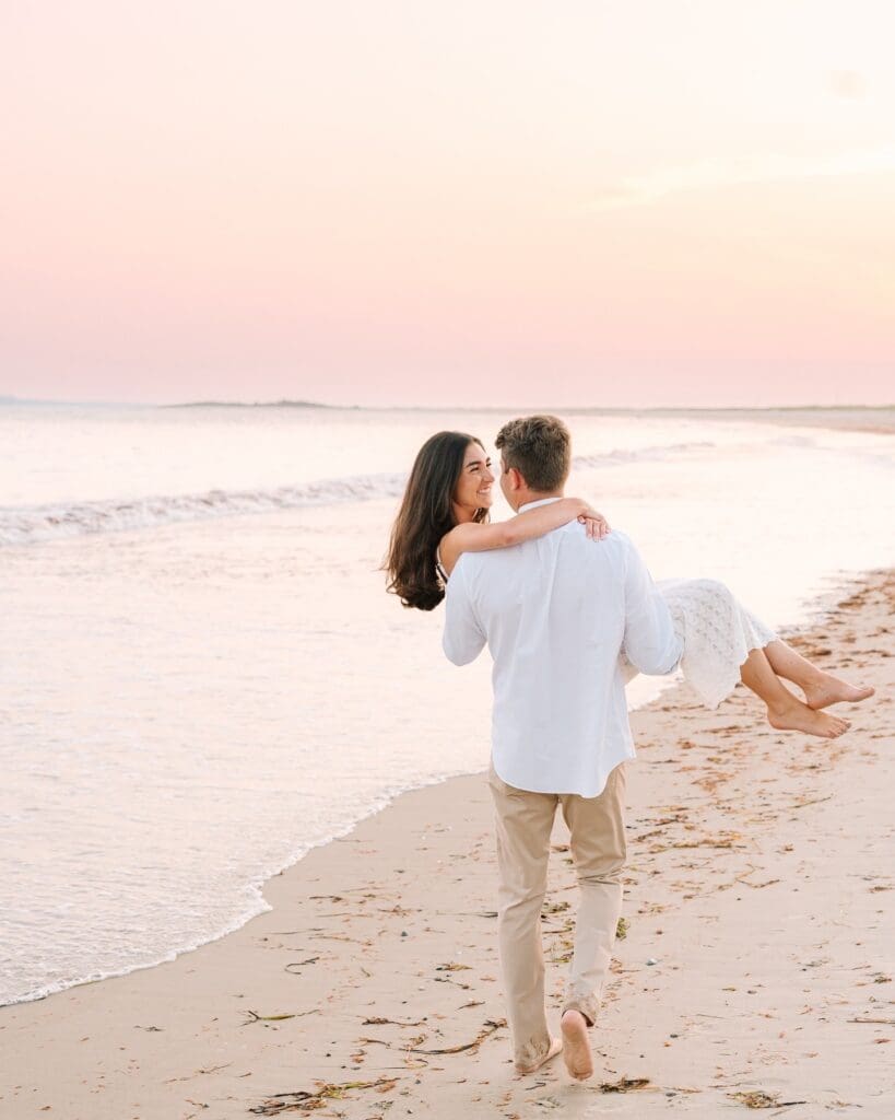 engaged couple on the beach in watch hill, ri